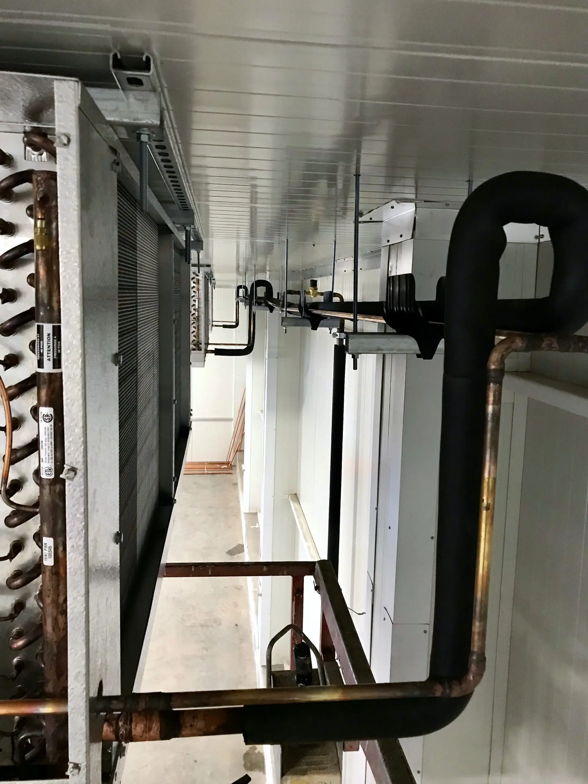 Copper piping and evaporator coils inside cold storage facility Fraser Valley