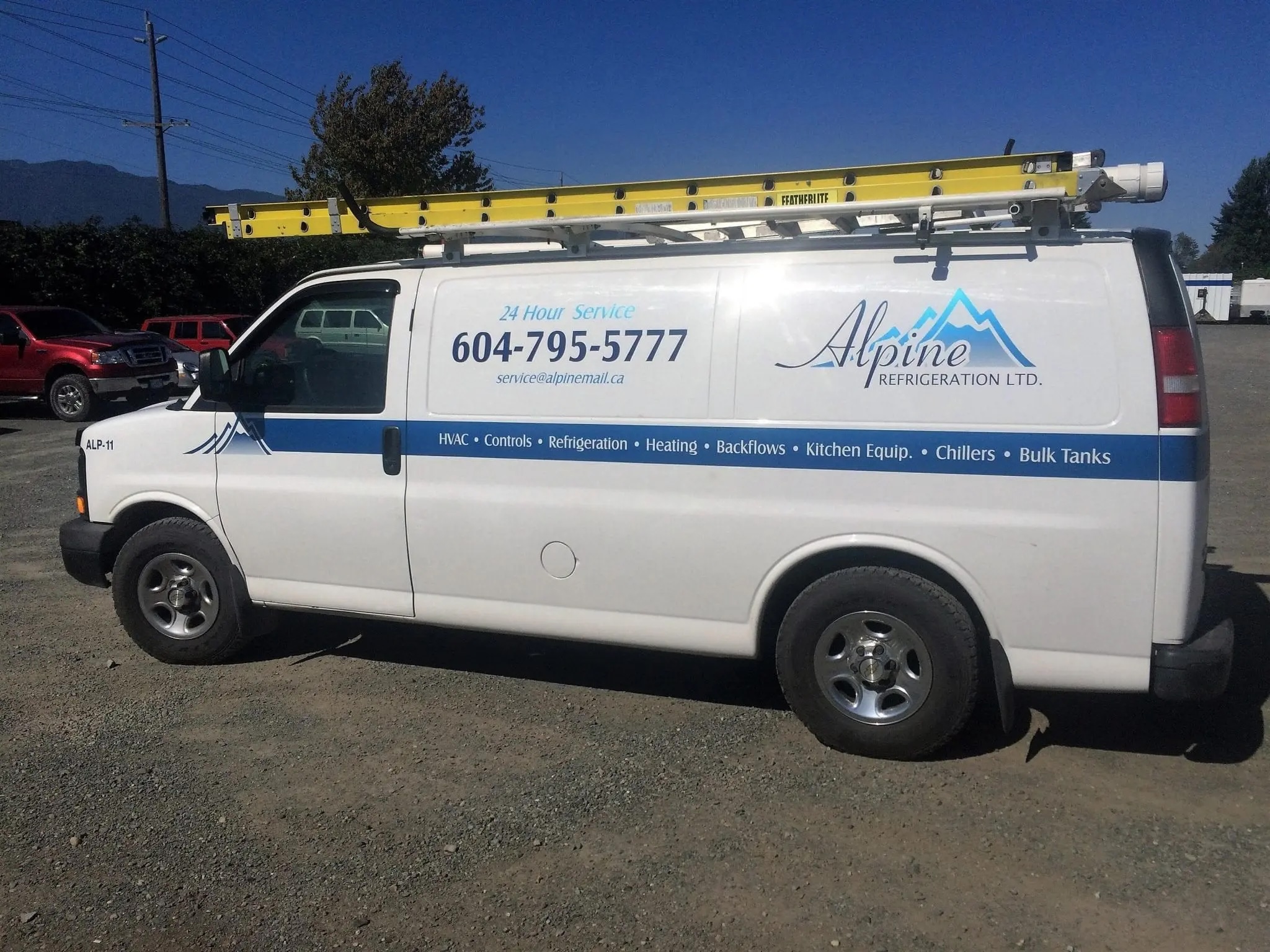 Alpine Refrigeration branded service van with equipment rack ready for refrigeration repairs