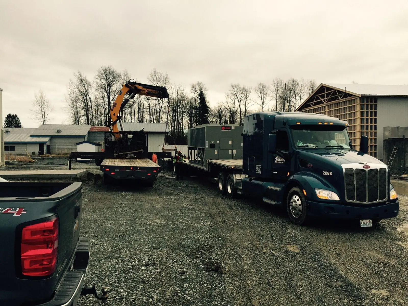 Trane HVAC equipment delivery by flatbed truck for commercial installation