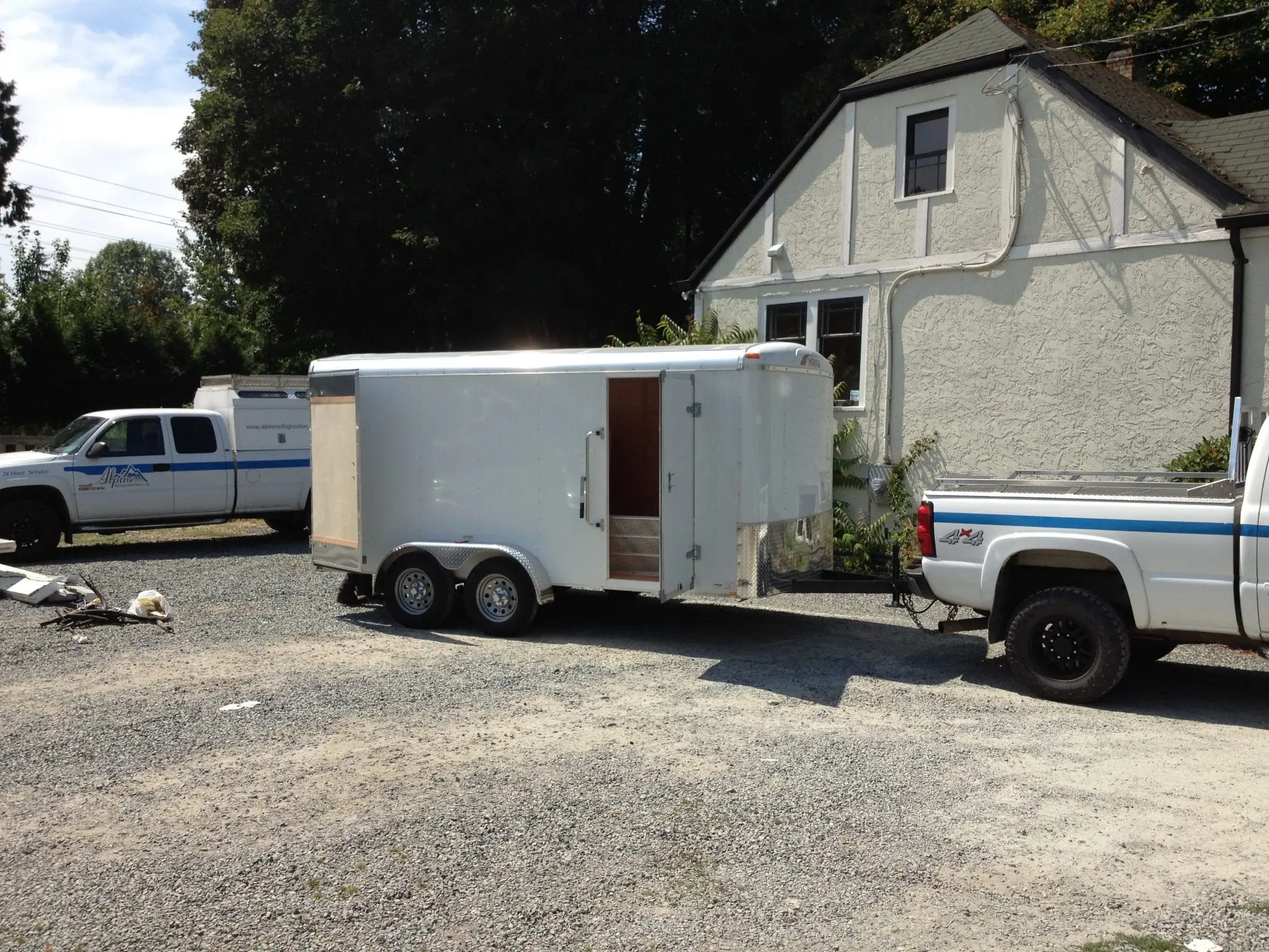 Alpine Refrigeration equipment trailer and service trucks at job site