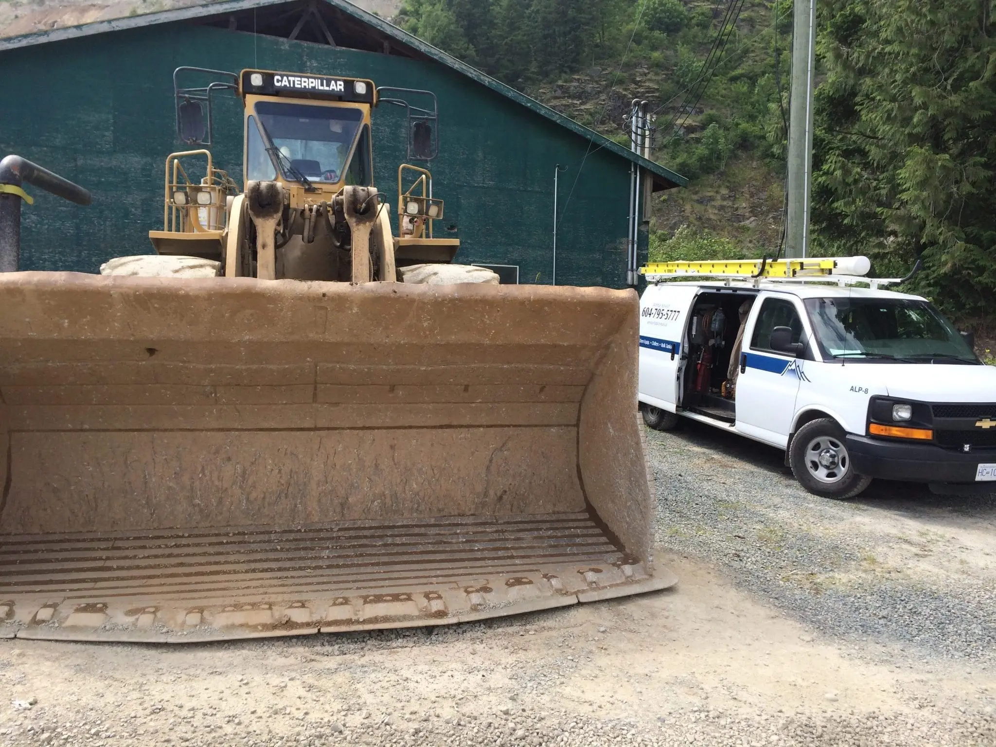 Alpine Refrigeration service van next to Caterpillar equipment at remote mining site