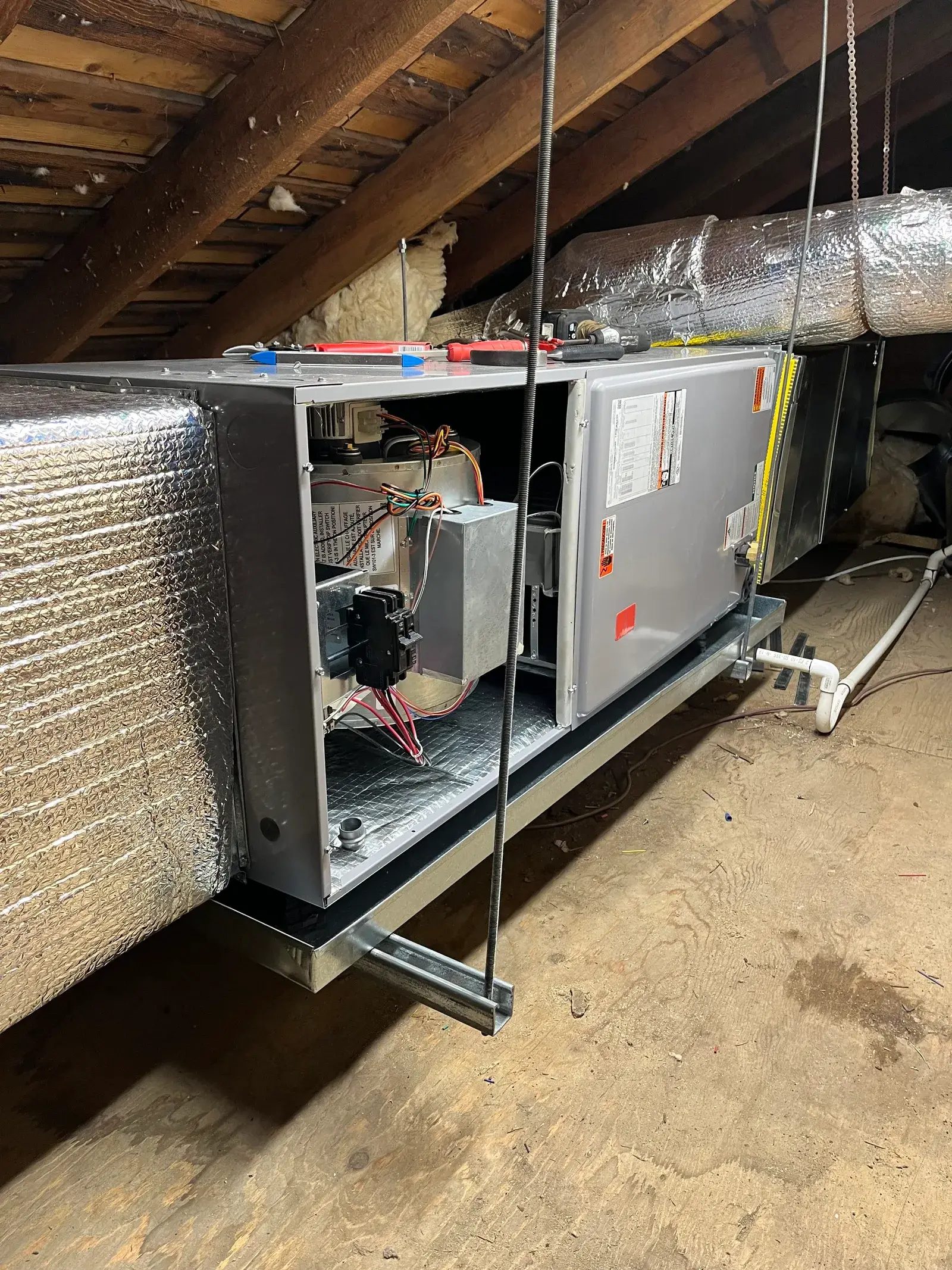 Commercial heat pump and air handler unit installed in mechanical attic - preventive maintenance