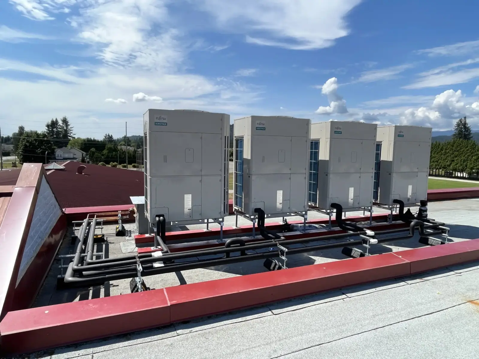 Row of Fujitsu AIRSTAGE VRF outdoor units on a Fraser Valley commercial rooftop retrofit
