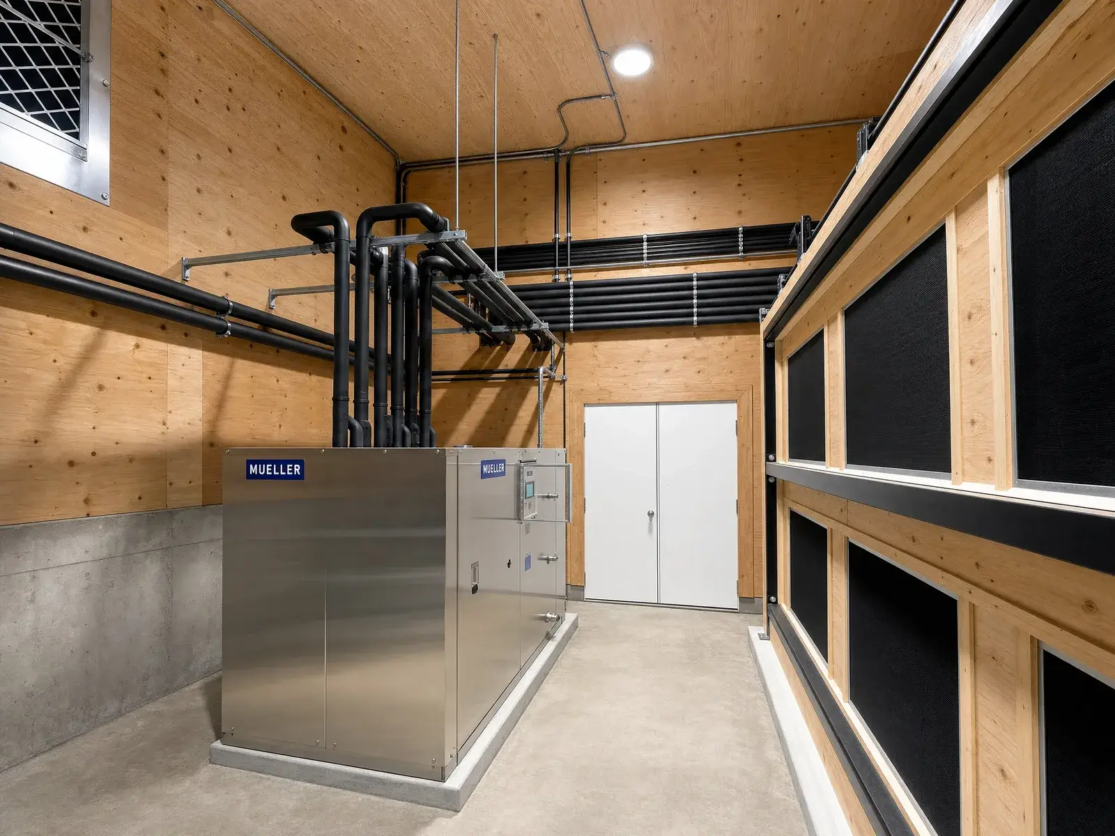 Mueller stainless refrigeration plant and glycol piping in a mass-timber dairy mechanical room - Fraser Valley