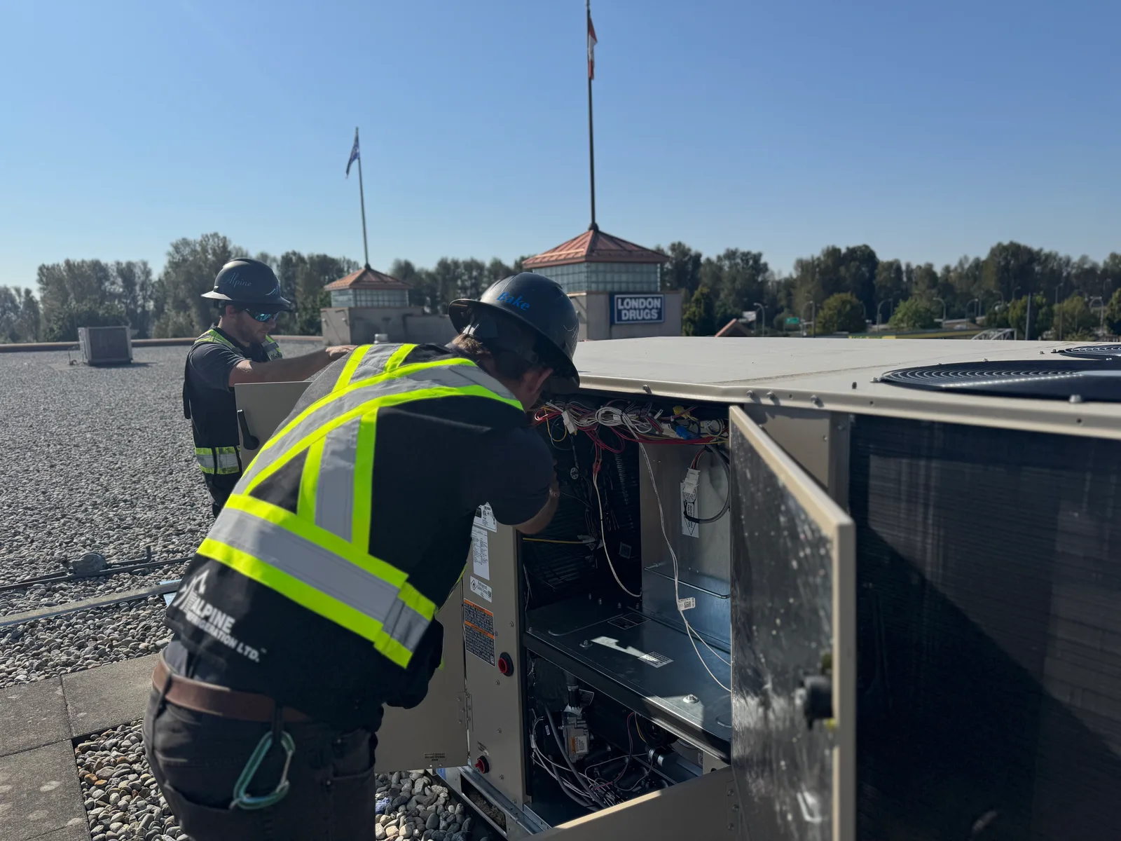 Alpine technicians servicing a rooftop packaged make-up air unit at a Fraser Valley commercial building