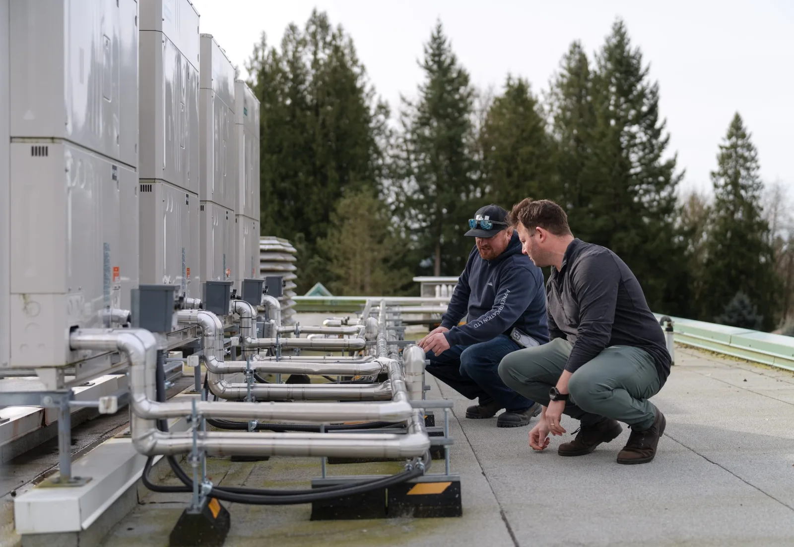 Technicians inspecting the Fujitsu AIRSTAGE VRF rooftop installation at Mission School District