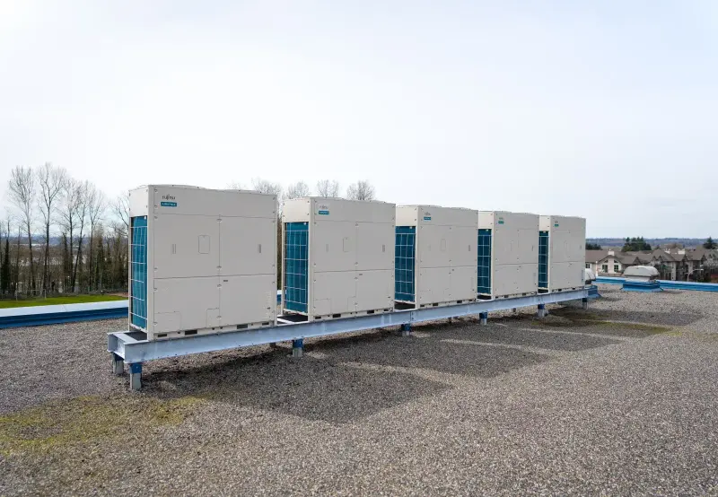 Five Fujitsu Airstage condensers on a shared steel rail