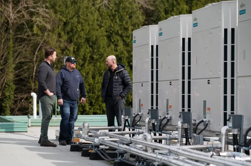 Alpine and Fujitsu teams reviewing the install on site