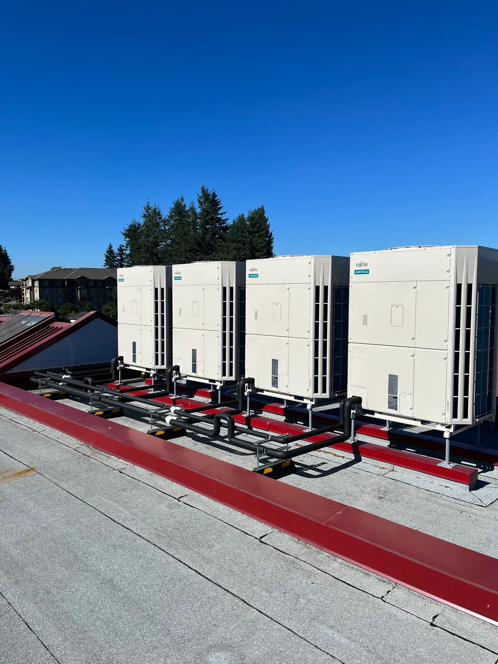 Completed Fujitsu Airstage rooftop array on the Mission Schools hybrid heat pump retrofit