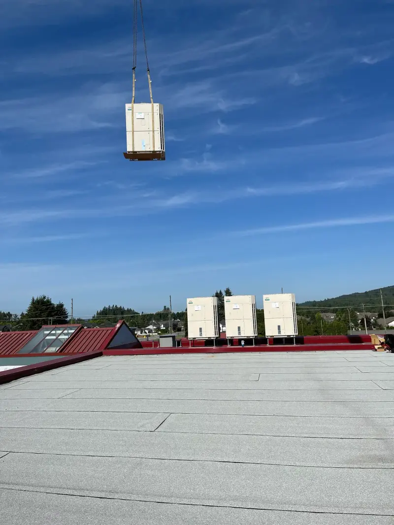 Craning a heat-pump unit onto the school roof
