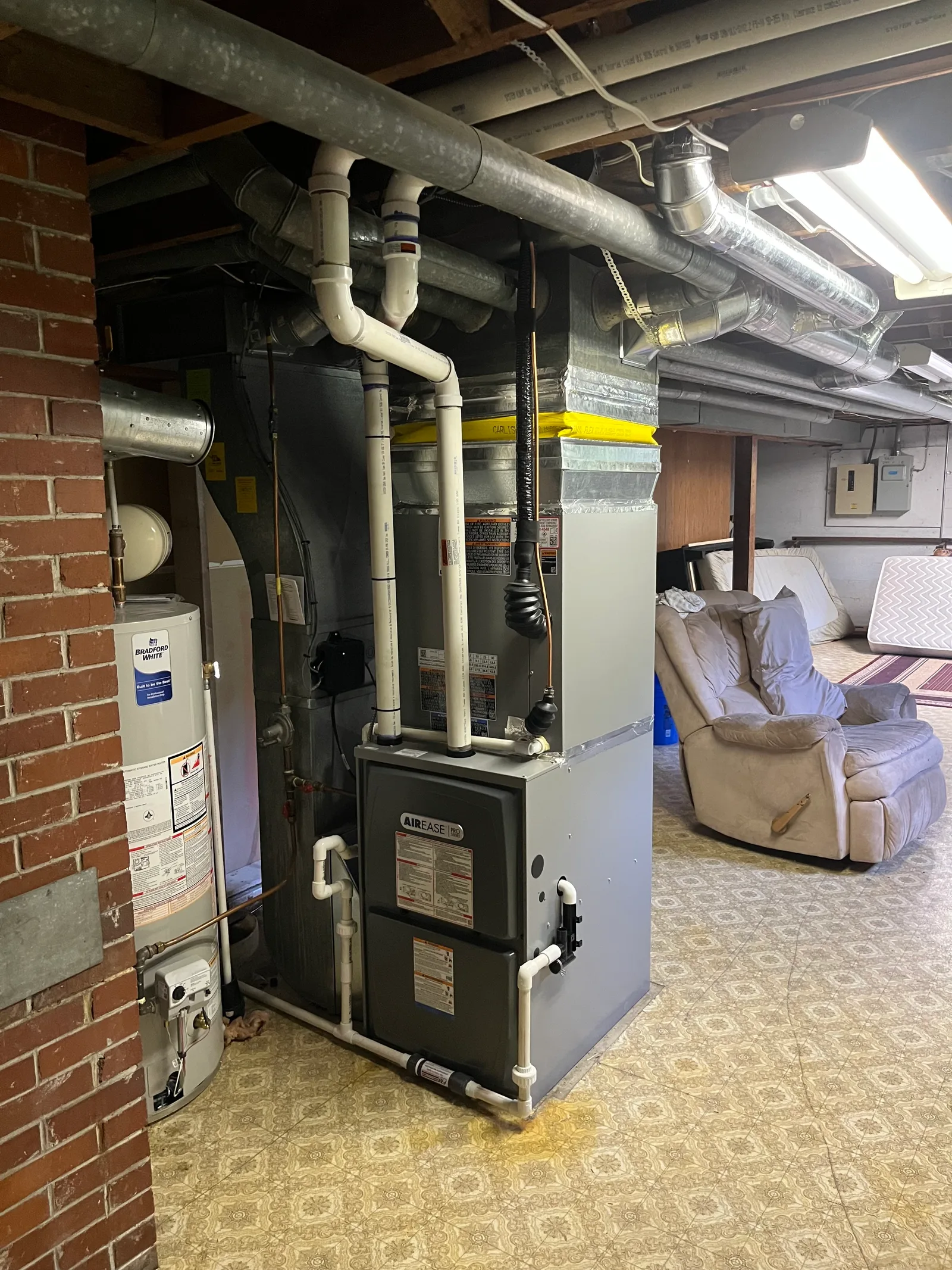 AirEase high-efficiency gas furnace installed in a residential basement by Alpine Refrigeration
