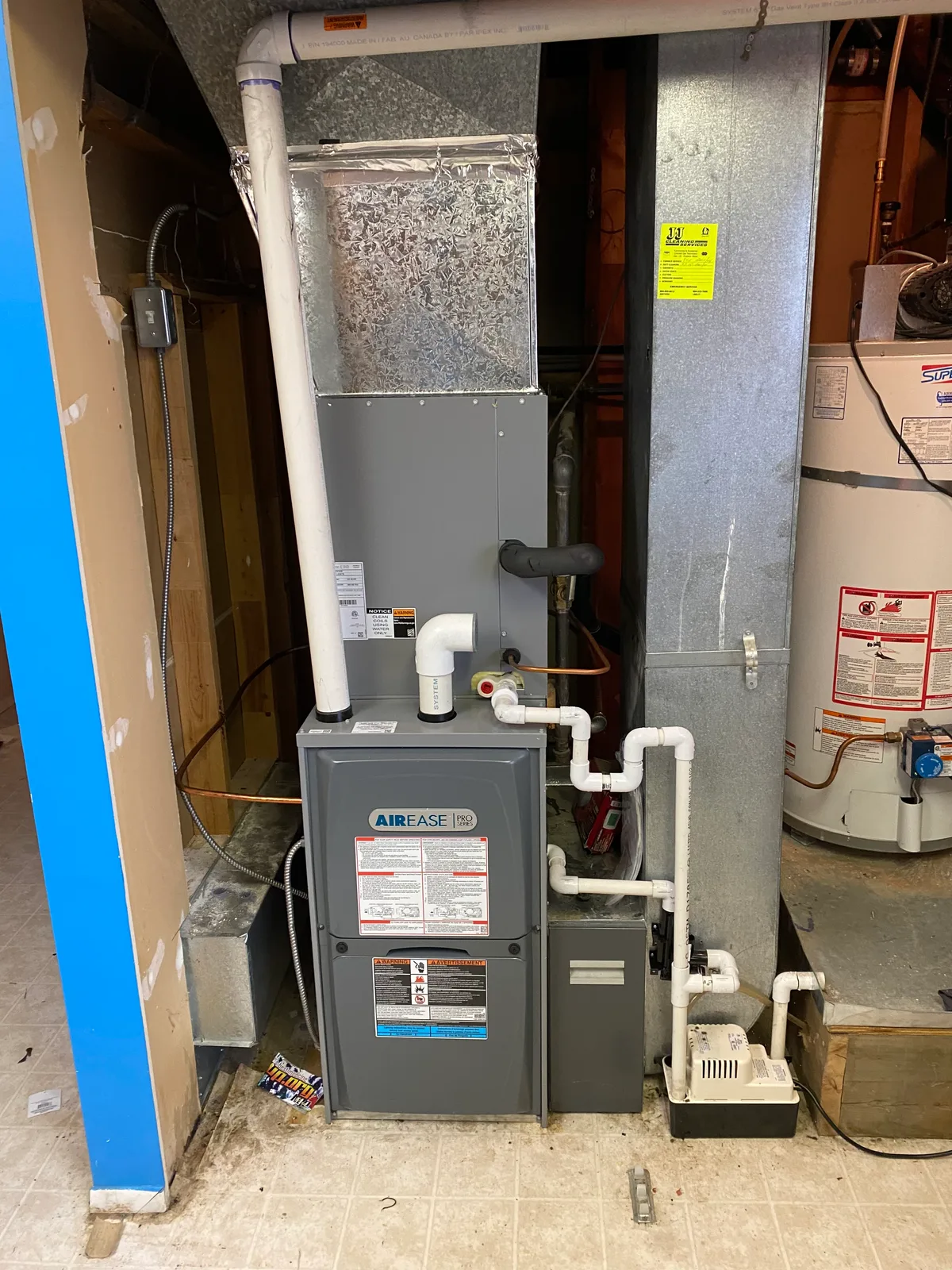 AirEase PRO high-efficiency gas furnace with condensate pump installed in a utility room