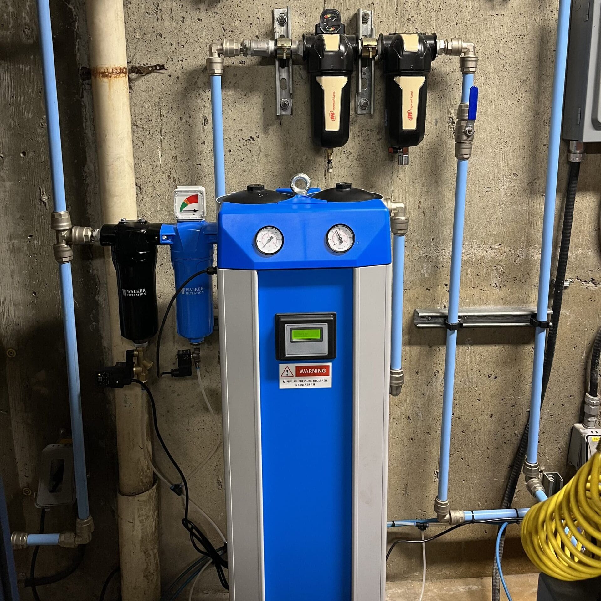 Farm HVAC filtration system with blue panel and gauges.